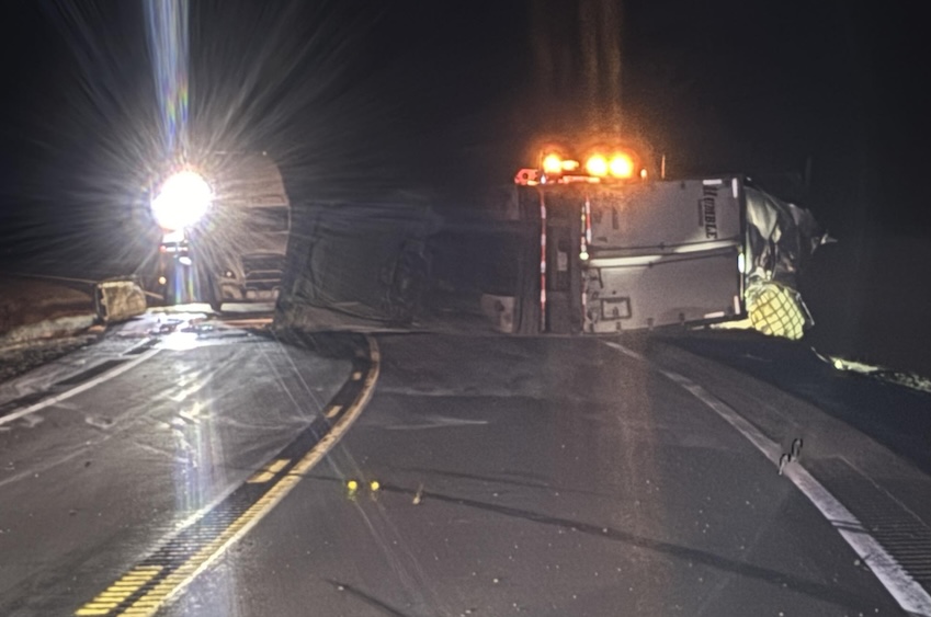 Driver sustains minor injuries following semi-truck rollover, North Dakota Highway Patrol temporarily closes road due to estimated 3,000-gallon hazardous materials spill